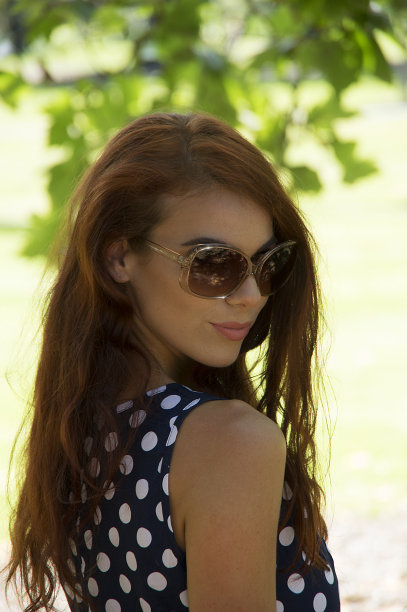 年轻的女士看她的肩膀图片下载