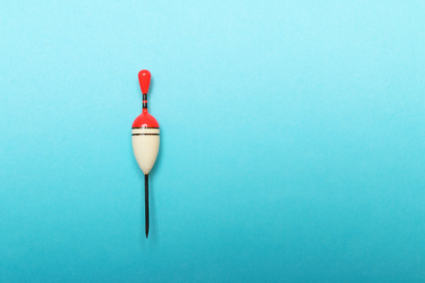 蓝色背景上自制的钓鱼漂。图片与你的文本空间。图片下载