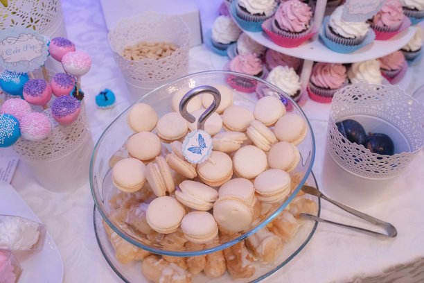 玻璃蛋糕架，上面有美味的法式马卡龙，还有一口就能吃到的小蛋糕图片下载