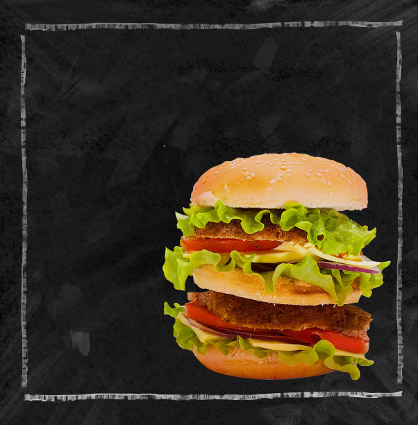 一个美味的汉堡在黑色的黑板上。文本。专为快餐爱好者准备。图片下载