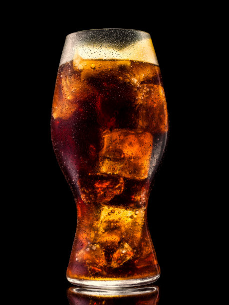 一杯苏打水和冰块在黑色背景图片下载