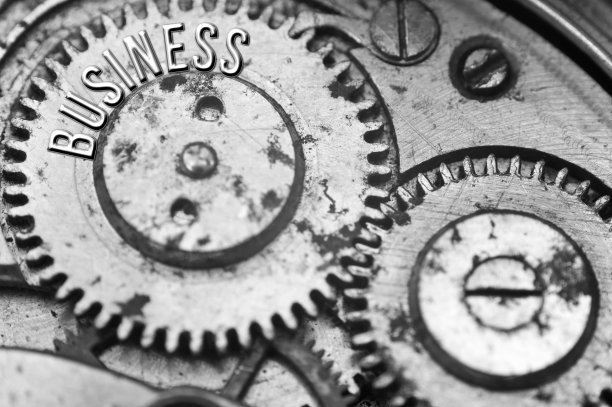 背景与铭文业务。黑白色背景与金属齿轮发条。宏。概念性照片为您成功的业务设计。金属黑白字母，齿轮。团队合作理念图片下载