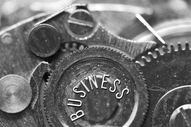 背景与铭文业务。黑白色背景与金属齿轮发条。宏。概念性照片为您成功的业务设计。金属黑白字母，齿轮。团队合作理念图片下载