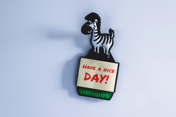 白色冰箱上贴着黄色贴纸，上面写着“祝你有个美好的一天”。图片下载