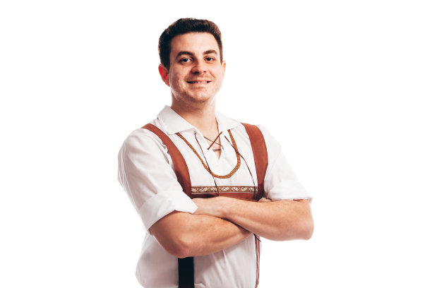 身着传统巴伐利亚服装的男子，手里拿着一大杯啤酒图片下载