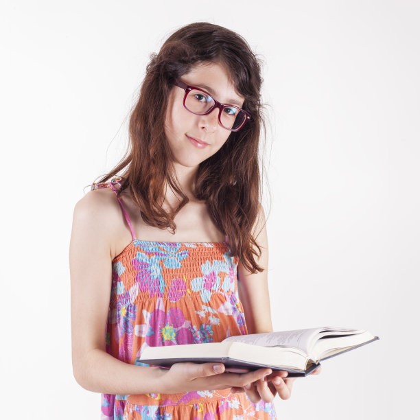 十几岁的女孩拿着一本书，在学习，工作室孤立在白色图片下载