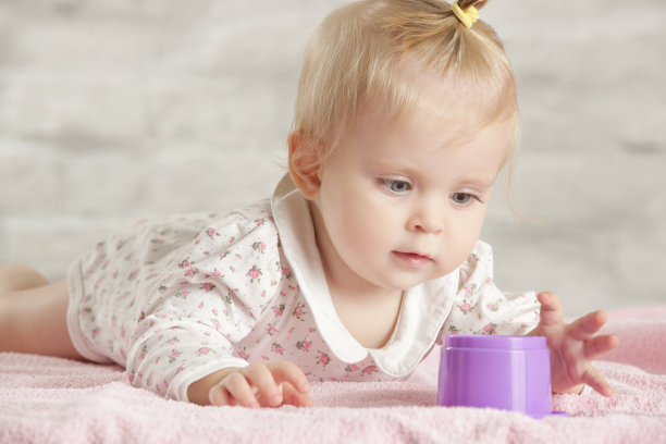 小女孩在地板上玩塑料教育杯，早期学习概念图片下载