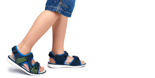 儿童皮凉鞋腿孤立在一个白色背景，复制空间模板图片下载