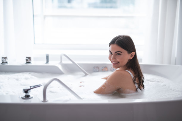 笑容满面的女士在浴缸里泡澡图片下载