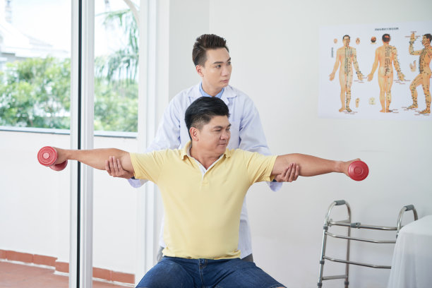 年轻医生帮助病人做运动图片下载