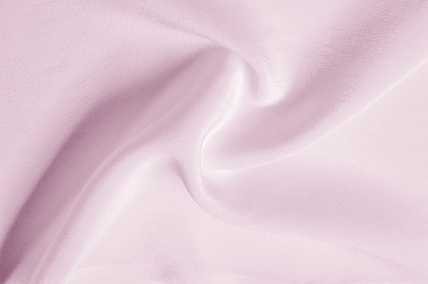 纹理背景图案。粉色丝绸织物。一个波纹的粉红色丝绸织物的特写。广告空间。光滑优雅的粉色丝绸可以作为婚礼的背景。图片下载