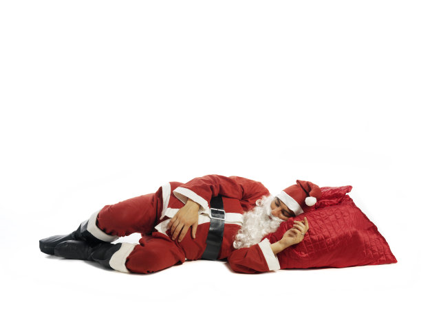 圣诞老人孤独地睡在白色的床上图片下载