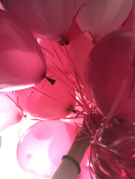 拿着一堆粉色的气球图片下载