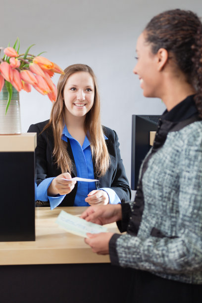 银行出纳员在零售银行柜台与客户打交道图片下载