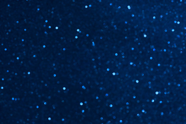 发光粒子，抽象的蓝色散景背景图片下载