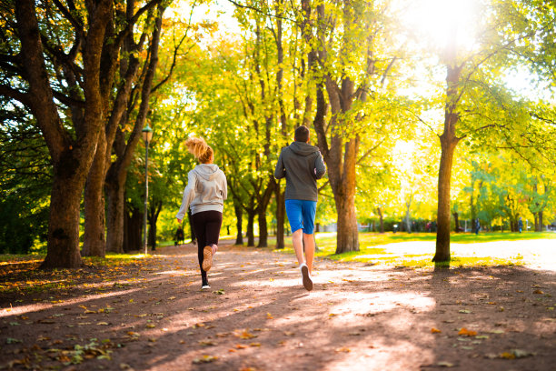 情侣在秋天的大自然中慢跑。图片下载