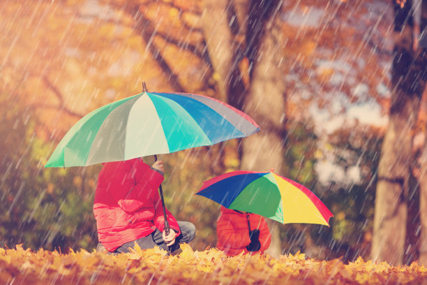 孩子们撑着伞在美丽的秋天图片下载