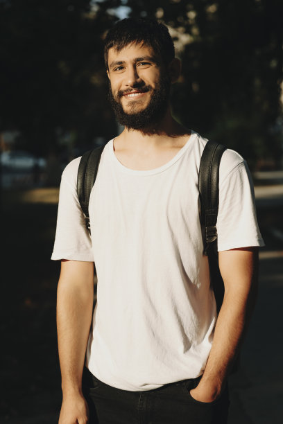 带着背包在户外微笑的大胡子男人图片下载