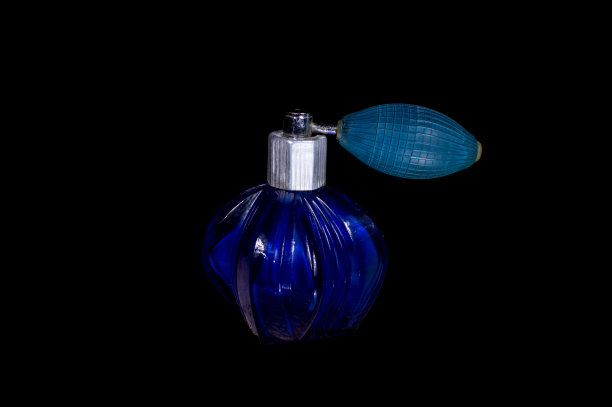 古老的蓝色香水喷瓶，孤立在黑色背景图片下载
