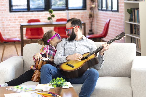 父亲和女儿戴着有趣的太阳镜弹奏乐器图片下载