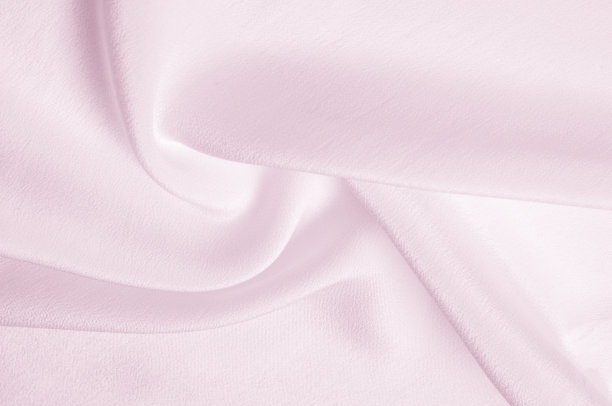 纹理背景图案。粉色丝绸织物。一个波纹的粉红色丝绸织物的特写。广告空间。光滑优雅的粉色丝绸可以作为婚礼的背景。图片下载