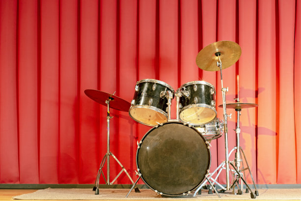 鼓被放在一个用红色窗帘的舞台上。图片下载