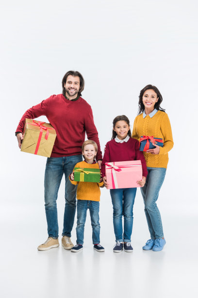 微笑的父母和孩子与包装的礼物看着孤立在白色的相机图片下载
