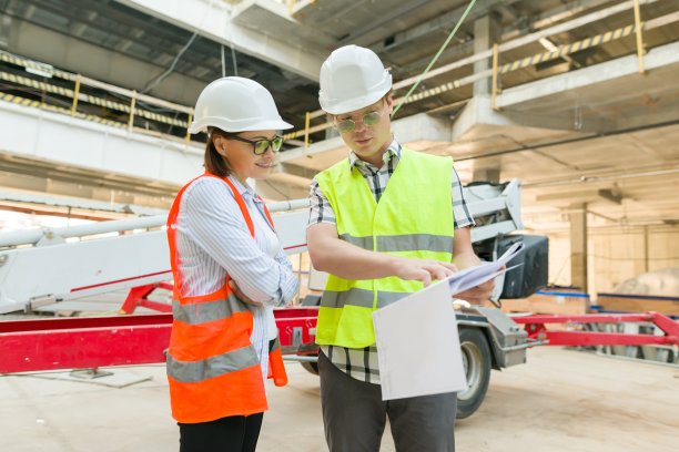 一名男工程师和一名女建筑师在建筑工地工作。建设、发展、团队、人本理念图片下载