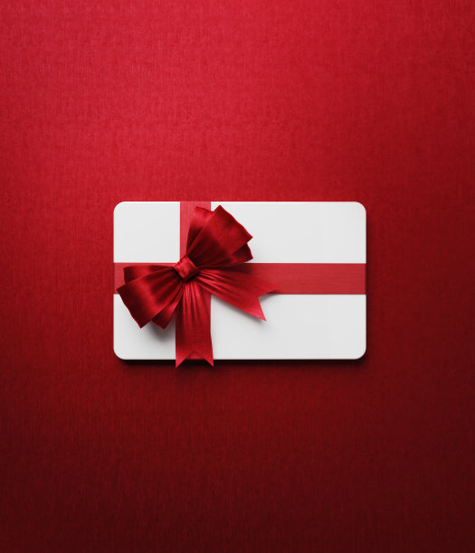 白色礼品卡与红色蝴蝶结领结在红色背景图片下载