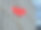 在一个以城市现代建筑为背景的建筑工地上，一个红色的吊钩和滑轮正在吊起一个悬挂的金属链图片下载