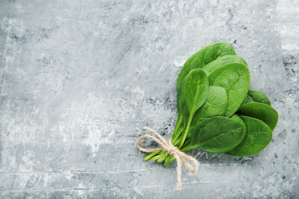 灰色的木桌上放着菠菜叶图片下载