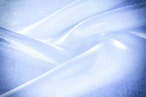 背景纹理、图案。蓝色的绸缎。光滑典雅的蓝色丝绸或缎子可以用作背景。奢华的圣诞背景或新年背景设计图片下载