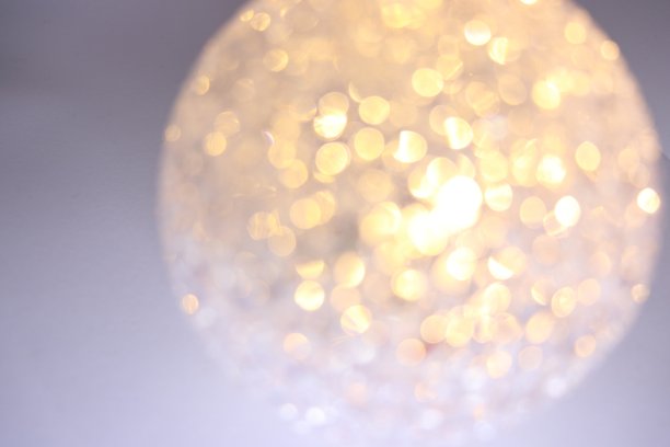 金色的散景模糊了白色背景上的背景纹理图片下载