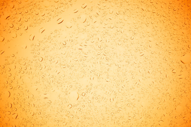雨滴落在黄色玻璃上，水滴落在黄色玻璃上。图片下载