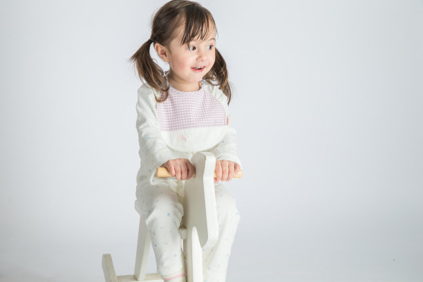 这个漂亮的小女孩骑着一匹木马图片下载