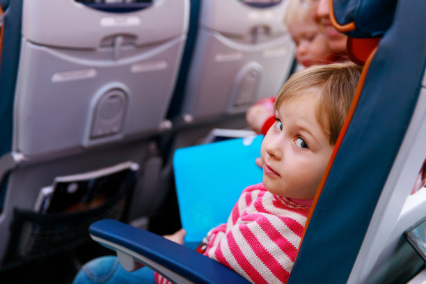 可爱的小女孩带着妈妈和妹妹乘飞机旅行，一家人在飞机上图片下载