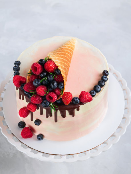 节日蛋糕与融化的巧克力和各种水果在一个华夫饼角在中性背景。副本的空间。垂直的。庆祝活动的概念。特写镜头。图片下载