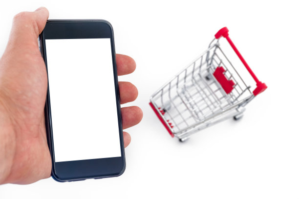 通过智能手机在线购物的概念。男人的手正拿着手机。白色背景上的金属车。关闭了。图片下载