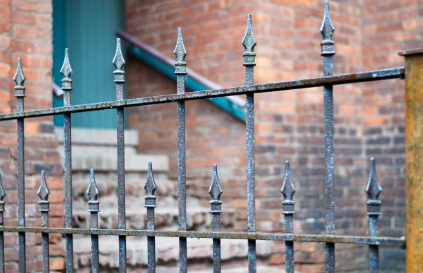 铁艺栅栏与砖墙背景。图片下载