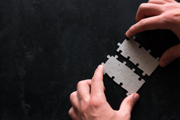 商人将黑色背景上的两块拼图商业概念与文本的位置联系起来图片下载