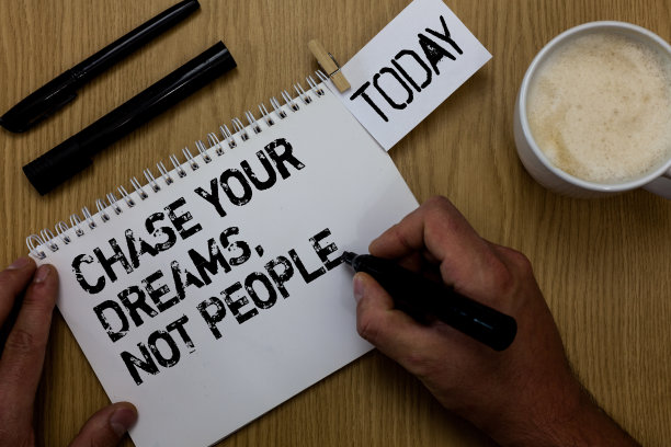 “追逐你的梦想，而不是别人”的文字标志。概念照片不要跟随别人追求目标目标回形针保留手写记事本手持记号笔咖啡黑笔在木桌上。图片下载