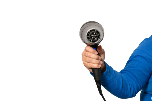 一个女人的手拿着吹风机图片下载