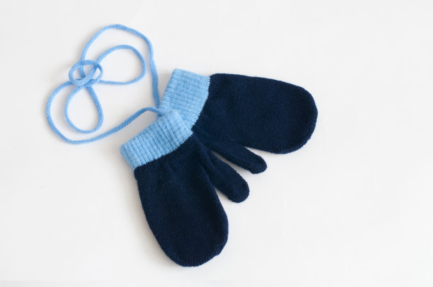 白色背景上的蓝色针织连指手套图片下载