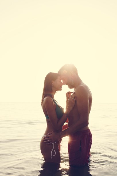 夕阳西下，海上浪漫的情侣图片下载