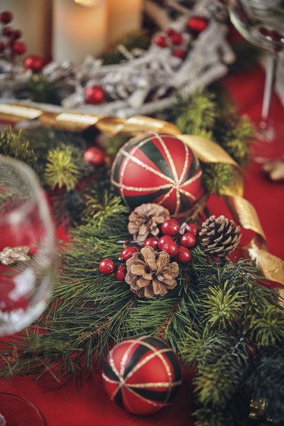 用蜡烛和圣诞装饰品装饰的圣诞晚餐的桌子图片下载