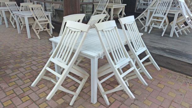 夏日咖啡馆里空荡荡的白色桌椅。夏天的餐厅。关闭图片下载