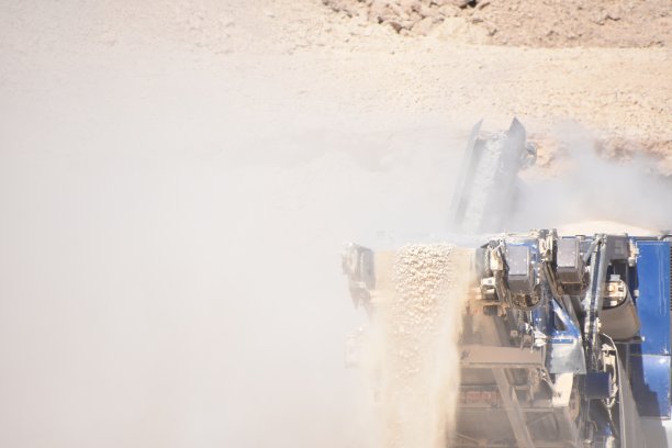 推土机将岩石装入粉碎机图片下载