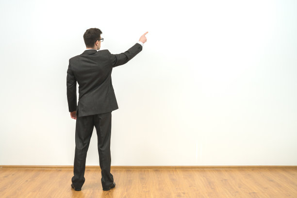 那个在白色墙壁背景上做手势的男人图片下载