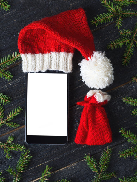 在圣诞老人的帽子和装满礼物的袋子里清空智能手机图片下载