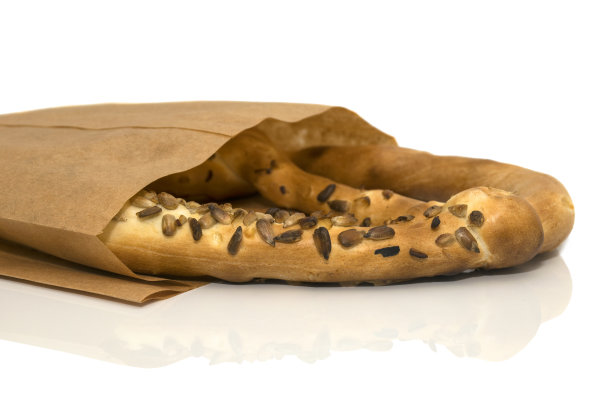 特写百吉饼在一个棕色纸袋躺在它的一边图片下载